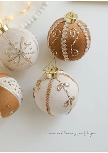 Detail of 8cm velvet Christmas baubles with gold embroidery, pearls and rhinestones