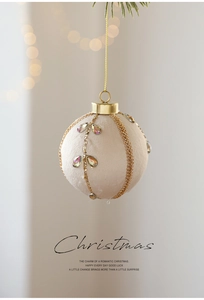 Detail of 8cm cream velvet Christmas ball with gold sequins and leaf pattern gems