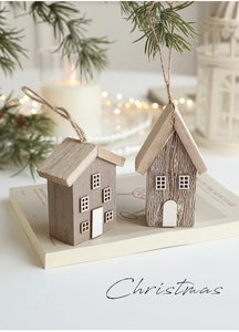 Detail of wooden Christmas house ornaments with rustic textures and hanging hemp ropes