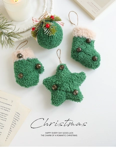 Close-up of green plush Christmas ornaments including star and bell with jute strings