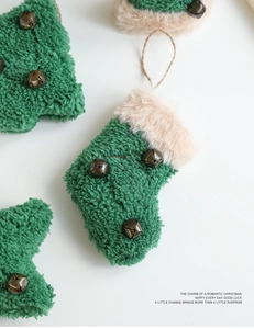 Detail of plush Christmas tree and stocking ornaments with mini bells and faux fur trim