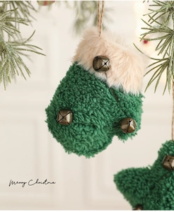 Detail of green sherpa mitten ornament with vintage metal bells and white faux fur trim