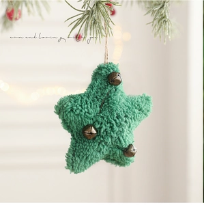 Close-up of green fuzzy star Christmas ornament with three vintage bronze bells and rope