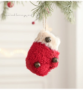 Detail of red plush mitten Christmas ornament with white fur trim and vintage bronze bells