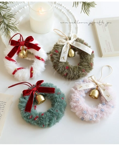 Set of four plush Christmas wreaths with festive bows, golden bells and Merry Christmas ribbons