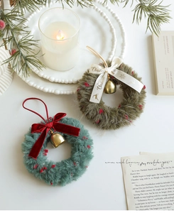 Detail of plush Christmas wreaths with velvet bows and golden bells on a cozy background