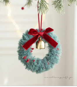 Close-up of plush Christmas wreath with red velvet bow and golden bell decoration