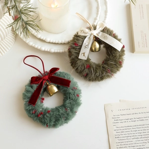 Plush Christmas wreath ornament with festive ribbon bow and golden bell decoration