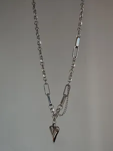 Detailed view of layered silver-tone link chain featuring a solid 3D heart-shaped pendant