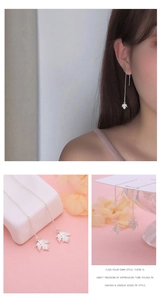 Detailed view of S925 sterling silver maple leaf tassel earrings on elegant model