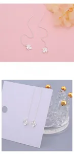 Detailed macro view of S925 sterling silver maple leaf tassel drop earrings for women