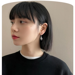 Close-up of a retro robot pendant earring in S925 silver worn by a model for a trendy look