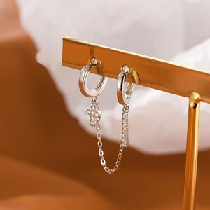 Detail of S925 sterling silver chain earrings with cross pendant and zircon inlay