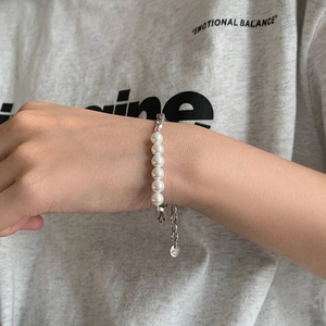 Elegant S925 sterling silver pearl bracelet with six round white pearls on a female wrist