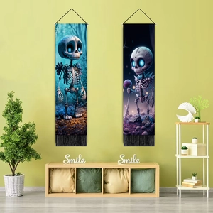 Detail of dark skull wall tapestries with blue glowing eyes and black bottom tassels