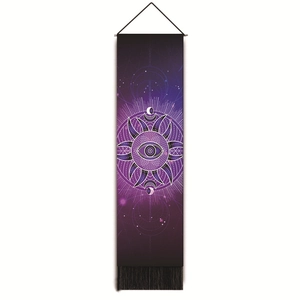 Detail of mystic eye tapestry with celestial sun and moon patterns and black tassels
