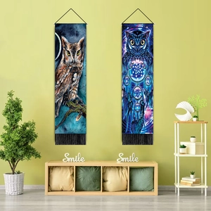 Detail of owl art tapestries with dreamcatcher designs and hanging tassels on wall