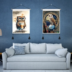 Close-up of owl wall tapestries with wooden hangers and black tassel decorations