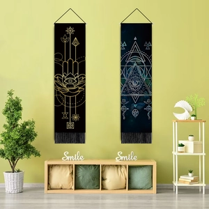 Detail of Nordic tapestry featuring Hamsa eye and geometric patterns with black tassels