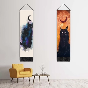 Lunar cat tapestries with black tassels hanging on white wall in a modern living room