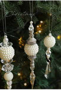 Detail of elegant pearl and crystal Christmas tree ornaments with silver accents