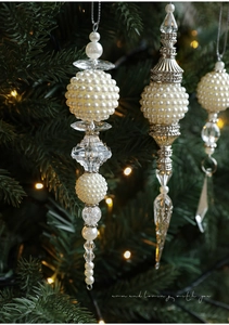 Close-up of icicle-shaped Christmas ornaments with white pearls and clear acrylic beads