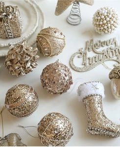 Detailed champagne gold Christmas tree ornaments featuring sequins, glitter, and pearls