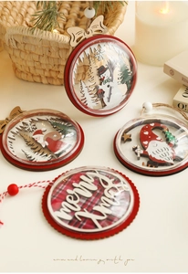 Detailed view of wood Christmas tree ornaments with snowman and Santa patterns in warm setting