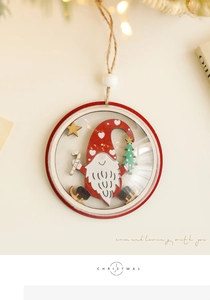 Close-up of wooden Christmas gnome ornament with red border and festive pine needle decor