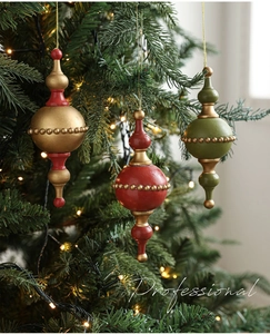 Detail of vintage finial Christmas ornaments with golden beads and hanging string