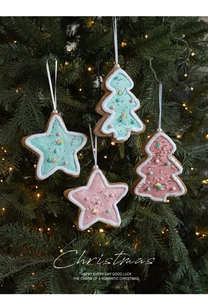 Detailed view of pink and blue star and tree ornaments with festive glitter and pearls