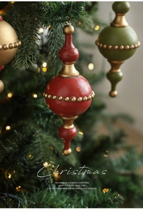Close-up of vintage Christmas tree ornaments with red and green royal palace style finish