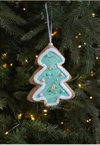 Detailed view of a light blue star-shaped ornament with colorful beads on a Christmas tree