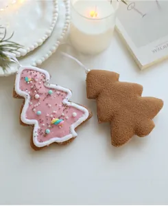 Detail of pink and brown felt Christmas star ornaments with beads in a cozy festive setting