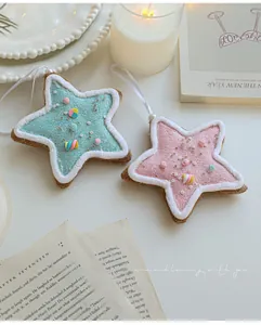 Detail view of pink and blue star Christmas ornaments with glitter and candy accents
