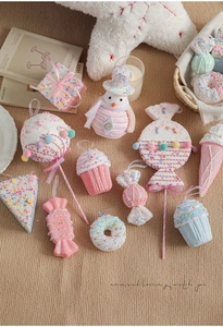 Macro shot of macaron pink Christmas candy ornaments with glitter frost texture on a table