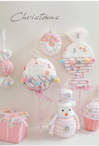 Detailed view of pink macaron candy Christmas tree ornaments with sequins and velvet