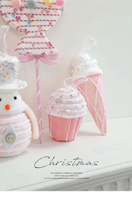 Detailed close-up of pink macaron candy and sweet cupcake Christmas tree ornaments