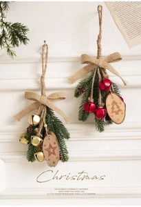 Detail of rustic Christmas ornaments with pine branches, bells, and wooden star charms