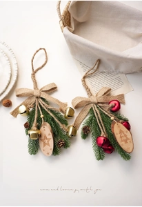 Detailed view of Christmas ornaments with bells, wooden tags and pine needle bows
