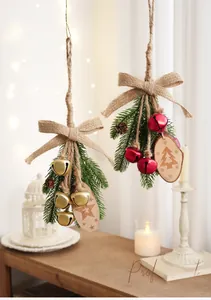 Christmas pine needle pendant with colored bells, linen bow and carved wood slices