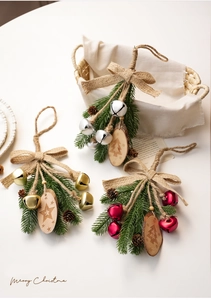 Detail of Christmas bells with rustic burlap bows pine cones and wooden star ornaments