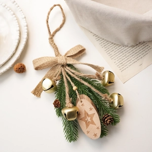 Christmas ornament with burlap bow, golden bells, pine cones and star engraved wood tag