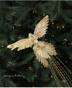 Detail of champagne gold bird ornament with pearls on Christmas tree branch
