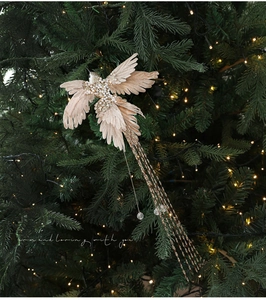 Macro detail of champagne artificial bird with pearls and sequins on a Christmas tree