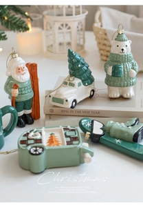 Festive ceramic Christmas ornaments featuring polar bear and truck in sage green and white