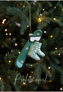 Detail of a skiing themed Christmas ornament with green skis and boots on a tree