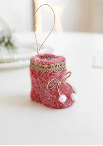 Detailed view of red felt Christmas boot ornament with gold lace and white pompoms