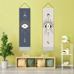 Detail of mysticism wall hangings with celestial eye and moon patterns on green wall