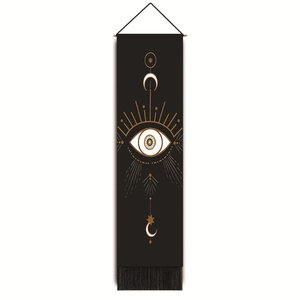 Close-up of bohemian wall tapestry with golden eye of providence and moon moon motifs